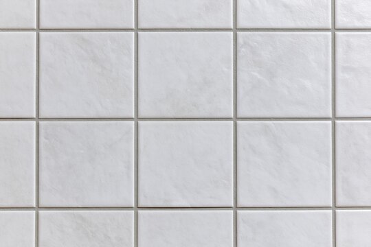 The White Tile Wall with Subtle Grout Lines Creating Quiet Texture