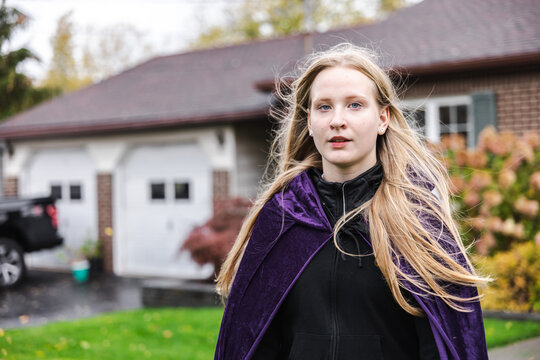 Young Woman Wearing Purple Cape for Halloween