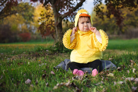 Pouting Toddler in Yellow Duck Costume for Halloween