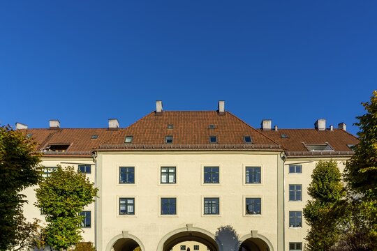 Torshov building archway facade with red roof and blue sky