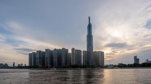 Sunset timelapse over Landmark 81 skyscraper and modern city skyline along the river in Ho Chi Minh City, Vietnam