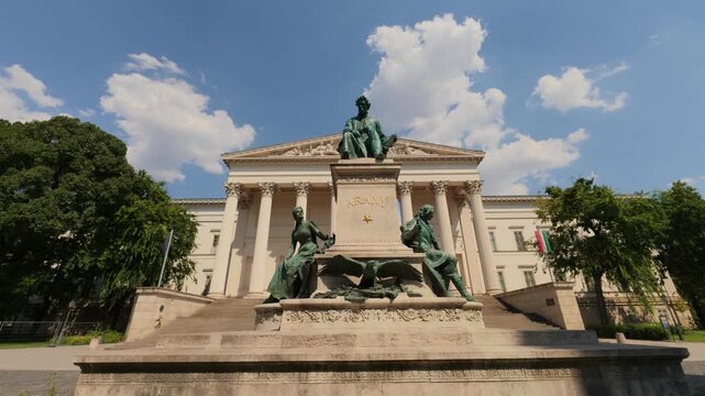 Budapest, Hungary - 19 August 2026: View of the Hungarian National Museum with the Arany Janos statue in front under a bright blue sky.