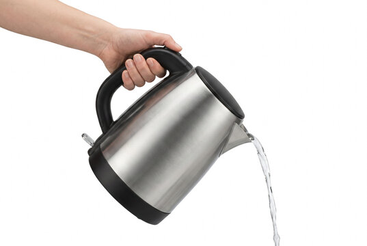 Hand Pouring Fresh Water From A Stainless Steel Electric Kettle