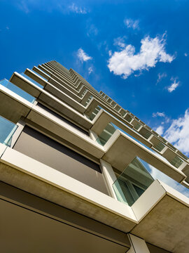 Tall building under clear sky. A building stands tall against the sky during the day. The view shows the structure from below looking up.