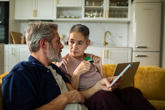Senior couple discussing online payment at home