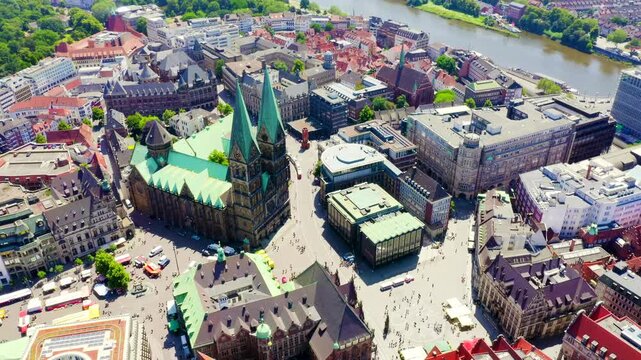 Bremen, Germany. St. Petri Dom twin spires and Hanseatic city center, aerial flight from Marktplatz toward the Schnoor quarter under bright summer sun. Drone footage, Point of interest