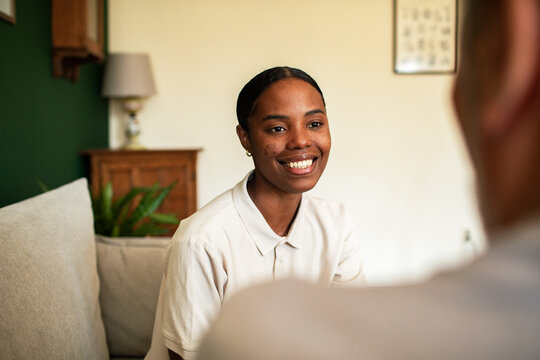 Smiling woman talking with client at home