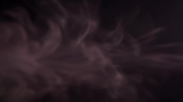 Ethereal colorful smoke plumes expanding outward from a dark center