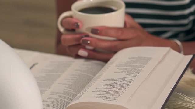 Woman Holding Coffee Cup Reading Holy Bible