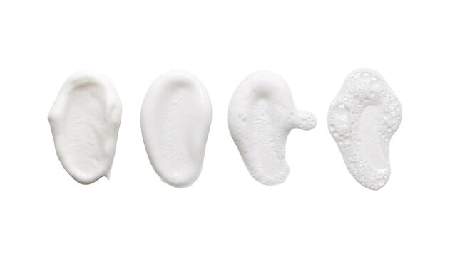 Four white cream foam swatches on transparent backdrop.