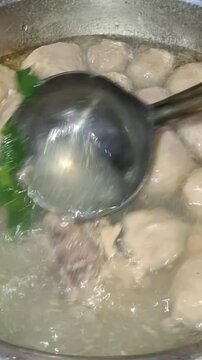 Meatball or bakso boiling in a pan