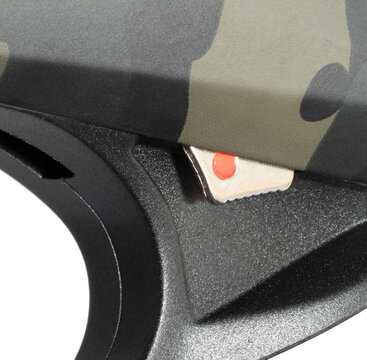 Close-up of the lever that's depressed to open a shotgun's chamber