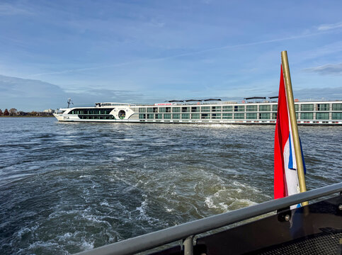 Dordrecht, Netherlands - 12 November 2025: Elegant five-star river cruise ship MS Oscar Wilde passing the historic city of Dordrecht in the Netherlands, luxury travel along European inland waterways.
