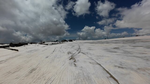 FPV aerial flight over snow-covered slopes of Mount Aragats