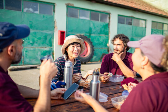 Farm workers taking lunch break at outdoor picnic table