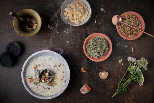 Incense ritual - aromatic frankincense, resins and dried herbs burning on hot charcoal