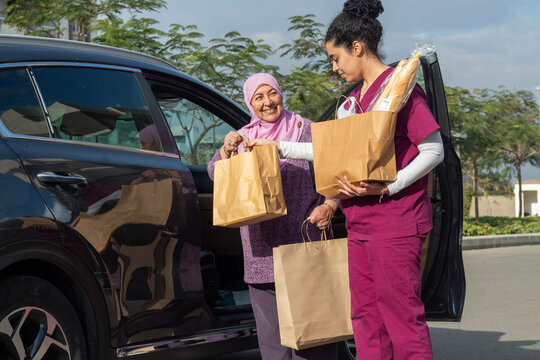 Senior and Caregiver with Groceries