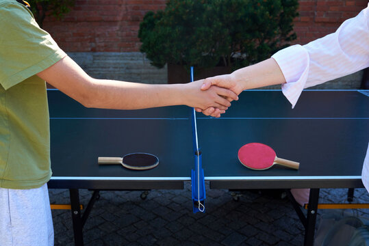 Players shake hands after a table tennis match 