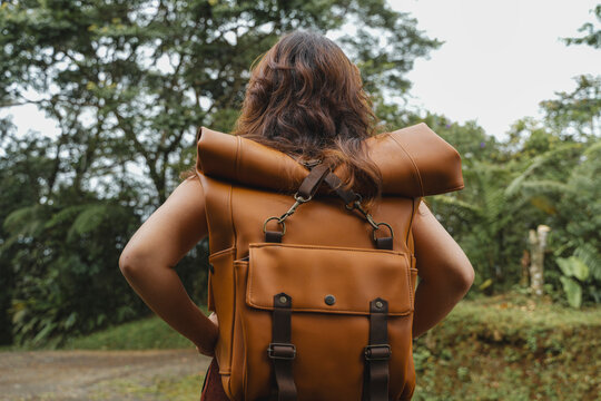 Adventurer hiking through rich green forest exploring nature