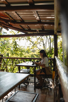 Remote worker using tablet on tropical balcony