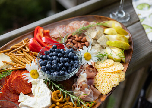Wine and charcuterie ready and setup on a balcony to enjoy.
