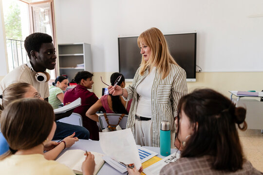 Teacher engaging diverse students during classroom discussion