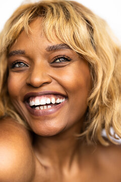Smiling Woman With Blonde Hair on Light Background