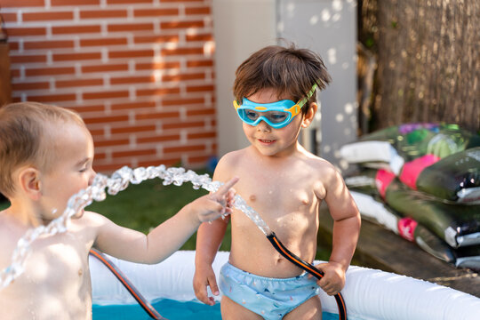 Boys Playing With Water Hose