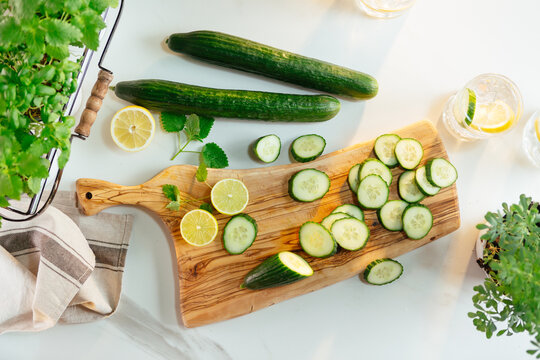 Preparing fresh cucumber lemon water detox drink