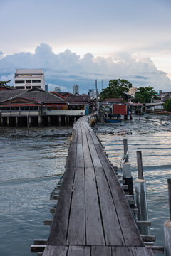 Wooden boardwalk leading to traditional waterfront village