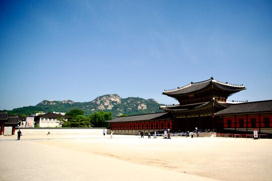 Wide view of a Korean palace courtyard and mountains