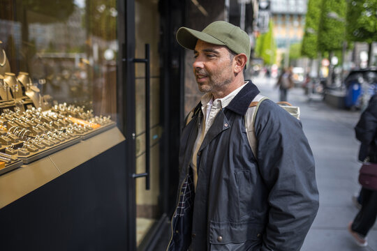 Mature man looking at jewelry shop window in Antwerp