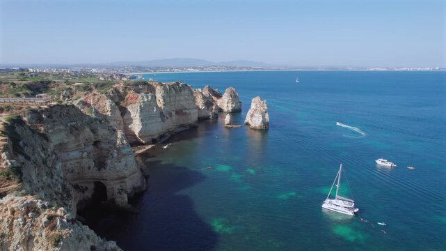Aerial view of the stunning Ponta da Piedade headland near Lagos in the Algarve region of Portugal. Rugged cliffs and sea stacks line the coast