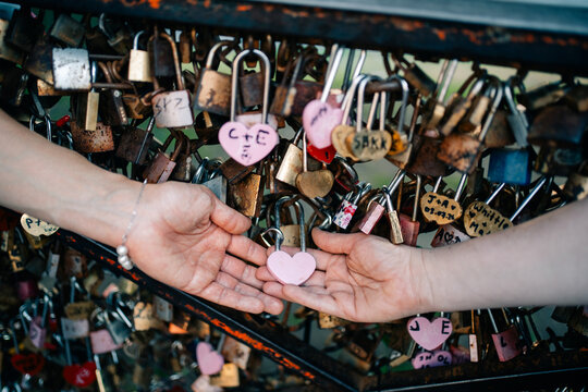 Couple Exchanges Heart-Shaped Lock at Love Lock Bridge