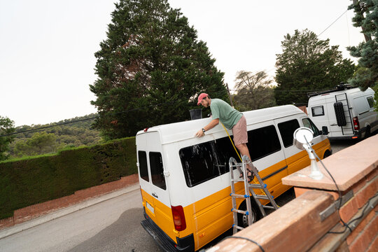 Man Washing Camper Van Roof