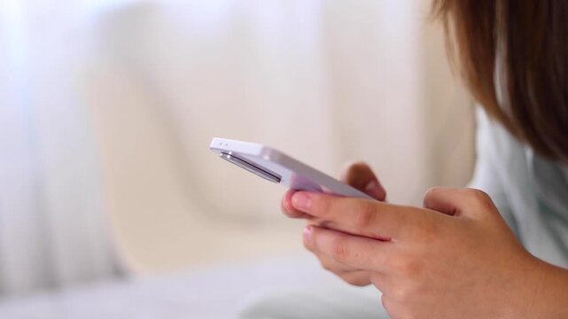 Close up of a woman using a smartphone for communication, browsing, social media, online activities and digital interaction.