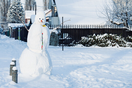 Cheerful Snowman by Fence