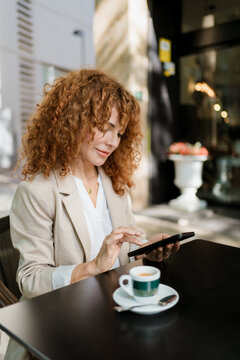 Businesswoman uses a Mobile Phone in a cafe