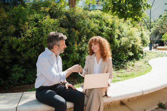 Business Colleagues Shaking Hands During a Meeting in City Park