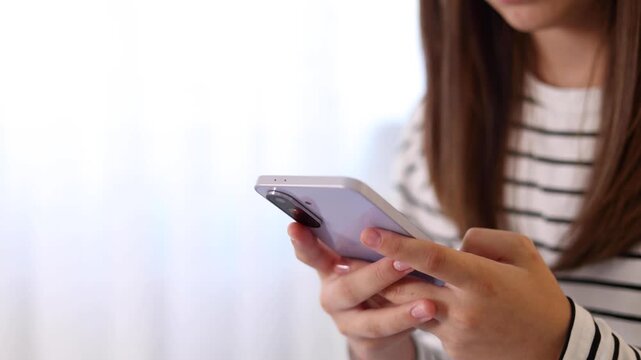 Close up of a woman using a smartphone for communication, browsing, social media, online activities and digital interaction.