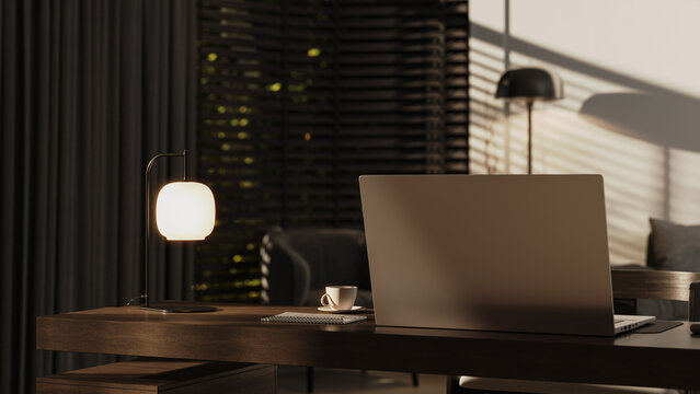 Modern home office workspace with laptop and warm evening lighting