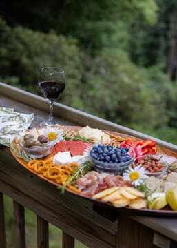 Wine and charcuterie ready and setup on a balcony to enjoy.