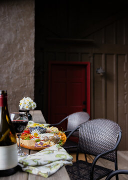 Wine and charcuterie ready and setup on a balcony to enjoy.