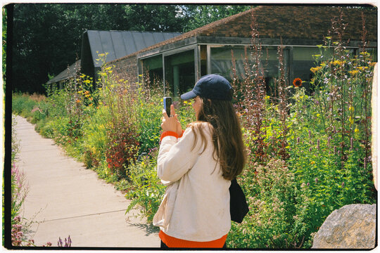 Analog medium shot of a tourist taking nature photos in Copenhagen