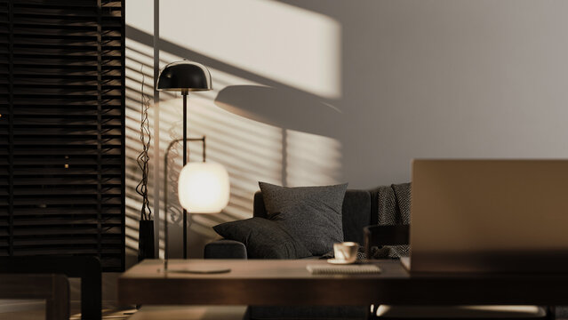 Modern home office workspace with laptop in warm evening light