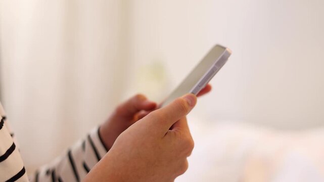 Close up of a woman using a smartphone for communication, browsing, social media, online activities and digital interaction.