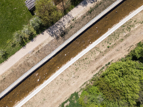 Aerial view captures river restoration work, focusing on channel cleaning and flood prevention measures.