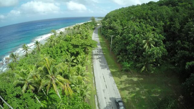 Aerial drone footage, coastal island road, Rota, Mariana Islands	