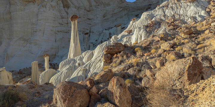 Beautiful wide scenic view of unique natural sandstone hoodoo rock formations under morning sunrise light
