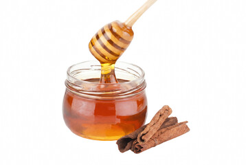 Golden Honey Dripping from Wooden Dipper into Glass Jar with Cinnamon Sticks © Farhana